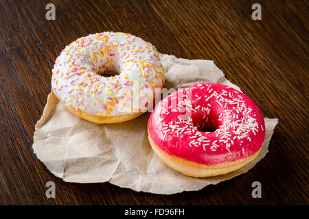 Two donuts on wooden backdrop Stock Photo