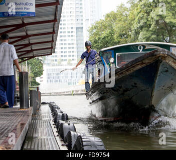 Public transport boat arriving at the pier on the canal Stock Photo