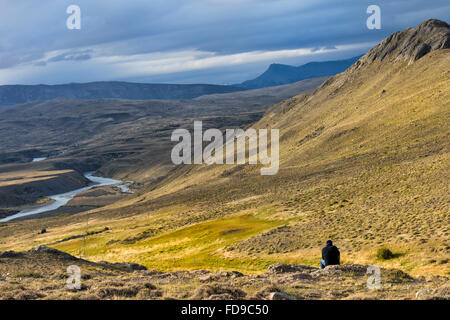 Man looking over the panorama of Torres del Paine National Park, Chilean Patagonia, Chile Stock Photo