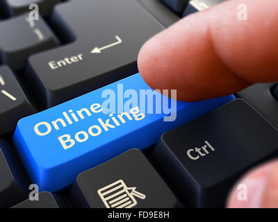 Computer User Presses Blue Button Online Booking on Black Keyboard. Closeup View. Blurred Background. Stock Photo