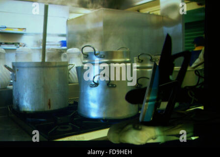 Projected image of industrial kitchen, over a retro iron on a boars Stock Photo