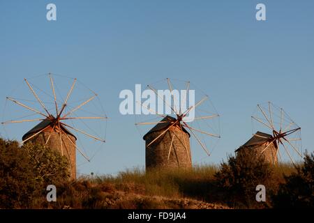 Restored windmills of the Monastery of St. John the Theologian at sunset, Chora, Patmos, Dodecanese Islands, Greece. Stock Photo