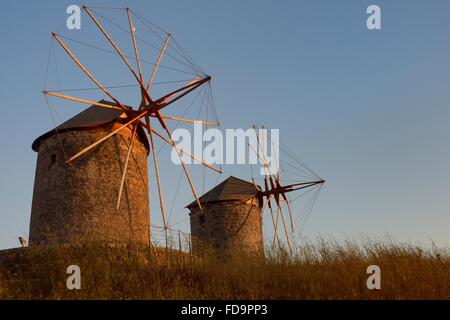 Restored windmills of the Monastery of St. John the Theologian at sunset, Chora, Patmos, Dodecanese Islands, Greece. Stock Photo