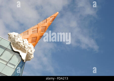 sculpture of an ice cream cone on the roof of shopping center