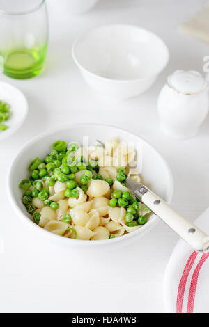 pasta with green peas in white bowl, fod close-up Stock Photo
