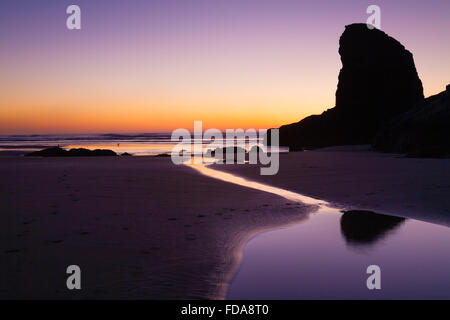 Sunset and tidal river in Cannon beach on Oregon's coast. Stock Photo