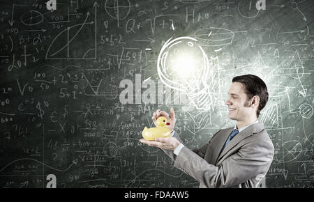 Funny businessman with yellow rubber duck toy Stock Photo