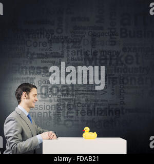 Funny businessman with yellow rubber duck toy Stock Photo