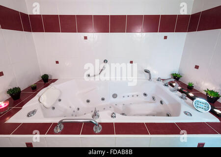 Jacuzzi bath with candles and plants Stock Photo
