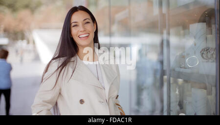 Laughing vivacious woman in a town street Stock Photo