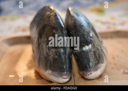 fresh gilthead bream on a wooden cutting board Stock Photo