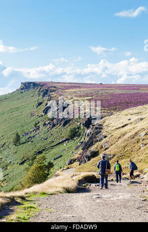 Walkers on Long Causeway at Stanage Edge, a gritstone escarpment on the Derbyshire Yorkshire border, Peak District, England, UK Stock Photo