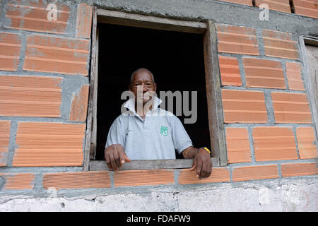 Old man looking out of window, afro-columbian village of Playa Bonita on the river Rio Andagueda, Chocó Department, Colombia Stock Photo