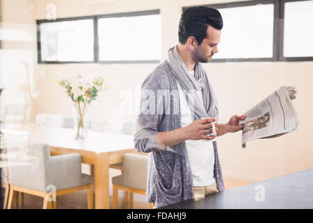 Handsome man reading newspaper Stock Photo