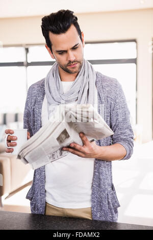 Handsome man reading newspaper Stock Photo