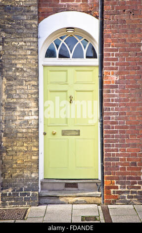 A yellow wooden door in an english town house Stock Photo