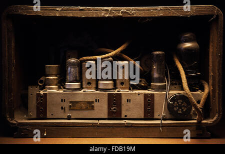 Old tubes and electric parts of an old dusty amplifier. Stock Photo