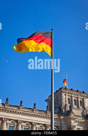 Flag of Federal Republic of Germany waving in front of the German parliament building (Reichstag) in Berlin, Germany Stock Photo