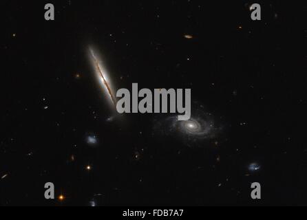 An edge-on spiral galaxy captured by the Hubble Space Telescope image found to have unexpected intense radio jets spewing out from its center January 25, 2016. Located about one billion light-years away in the constellation of Eridanus and known as LO95 0313-192. Stock Photo