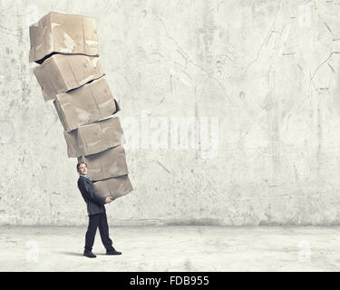 Businessman carrying big stack of carton boxes Stock Photo