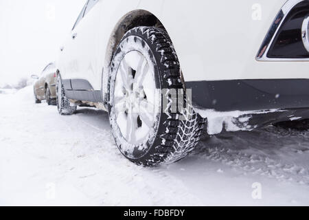 cars with winter tires are on the snow-covered ground Stock Photo