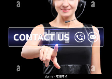 business woman presses a button on the touch screen. contact us Stock Photo