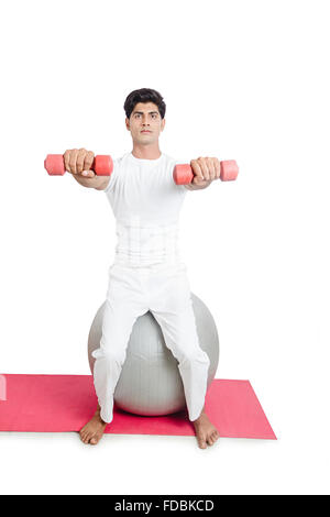 1 Young man Sitting Fitness ball  Holding Hand weights Exercising Stock Photo