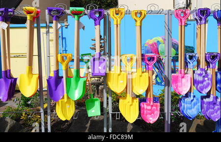 Seaside spades for sandcastles in a shop in Exmouth, Devon, England, UK Stock Photo