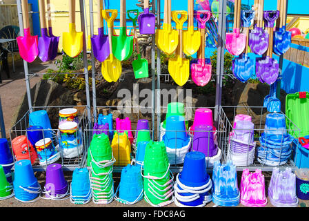 Seaside spades for sandcastles in a shop in Exmouth, Devon, England, UK Stock Photo