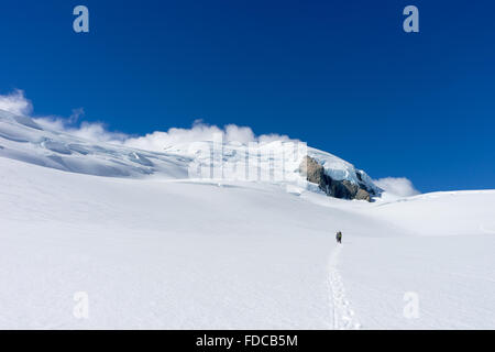 People walking among snows of New Zealand mountains Stock Photo