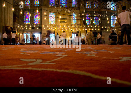 ISTANBUL - SEPT 6: Muslim people are praying in one of the landmarks of istanbul historical mosques, Sultanahmet, located in old Stock Photo