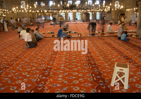 ISTANBUL - SEPT 6: Muslim people are praying in one of the landmarks of istanbul historical mosques, Sultanahmet, located in old Stock Photo