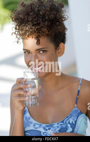 Young Hispanic woman with waterglass Stock Photo