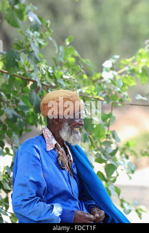 DEBRE BIRHAN, ETHIOPIA-MARCH 24: Blue dressed old man sits on the Baresa river bridge-waits grandson to come back from school. Stock Photo