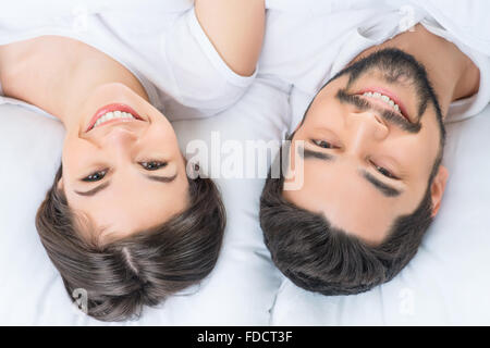 Nice loving couple lying in bed Stock Photo