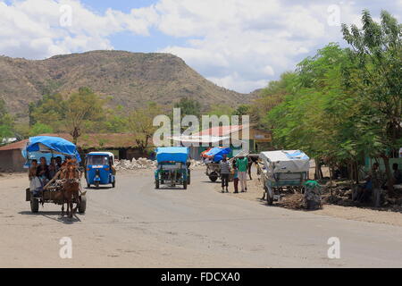 DEBRE BIRHAN, ETHIOPIA-MARCH 24: Horse carts and auto ricks transport local people-kids back from school down the main street. Stock Photo