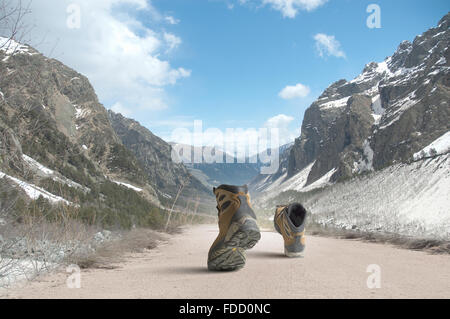 Pair of hikers boots walking on path Stock Photo