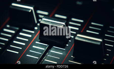 Details of a sliders of a modern midi controller, audio studio music equipment. Stock Photo