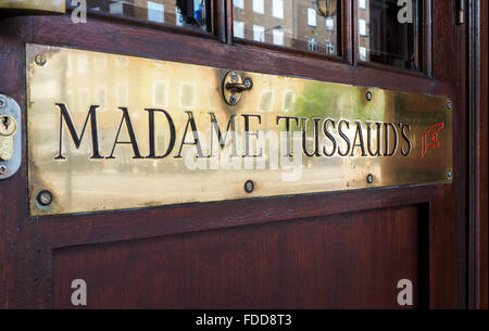 Detail of entrance of Madame Tussaud's museum with brass ensign and wooden door. Stock Photo