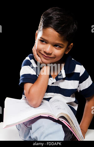 1 indian Kid Boy Student Reading Book Stock Photo