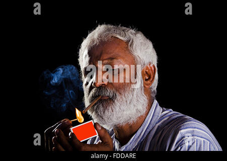 1 indian Senior Adult Man Matchstick Burning Cigarette Smoking Stock Photo