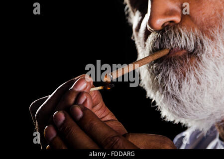 1 indian Senior Adult Man Matchstick Burning Cigarette Smoking Stock Photo