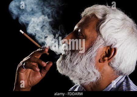 1 indian Senior Adult Man Journalist Book writing Stress smoking Cigarette and Drug Abuse Addiction Stock Photo