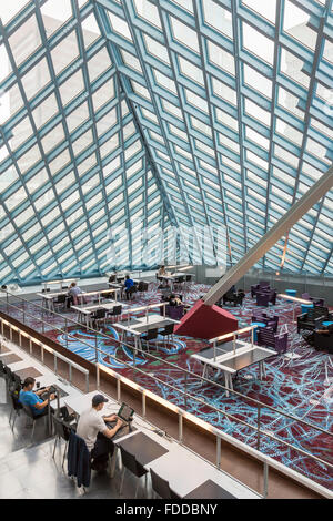 People studying & using laptop computers with wifi in the main reading room of the Seattle Central Library, Seattle, Washington Stock Photo