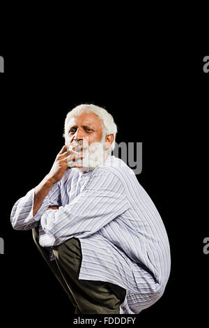1 indian Senior Adult Man Villager Sitting Smoking Bidi Stock Photo