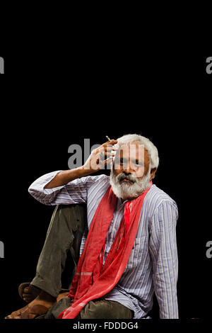 1 indian Senior Adult Man Villager Sitting Smoking Bidi Stock Photo