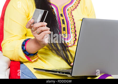 1 indian Adult Woman sitting sofa Credit Card and laptop online shopping Stock Photo