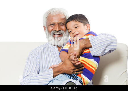 2 People GrandFather and Grandson sitting sofa fun Stock Photo