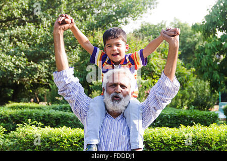 2 People GrandFather and Grandson Park Carrying On Shoulders enjoy Stock Photo