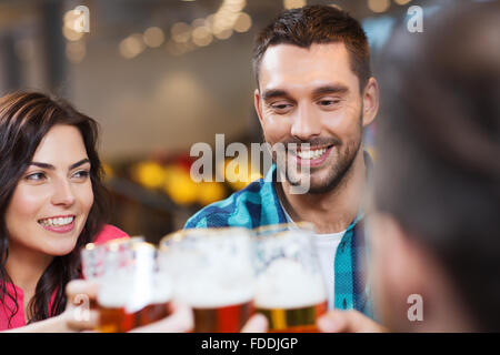 friends dining and drinking beer at restaurant Stock Photo